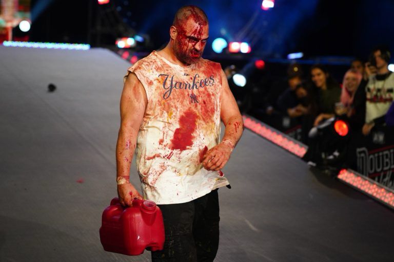 Eddie Kingston at AEW Double or Nothing 2022, covered in blood as he walks down the ramp with a gas can to light Chris Jericho on fire