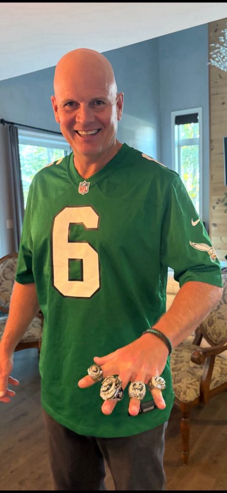 Me wearing a Devonta Smith Eagles jersey wearing the Eagles two Super Bowl rings and their two most recent NFC Championship rings. 