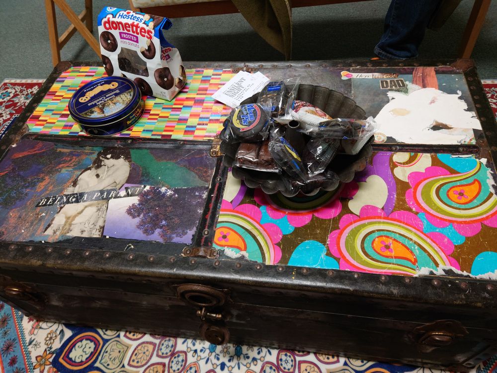 Snacks on a decorated steamer trunk serving as a coffee table.