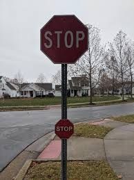 A stop sign with a smaller stop sign underneath it 