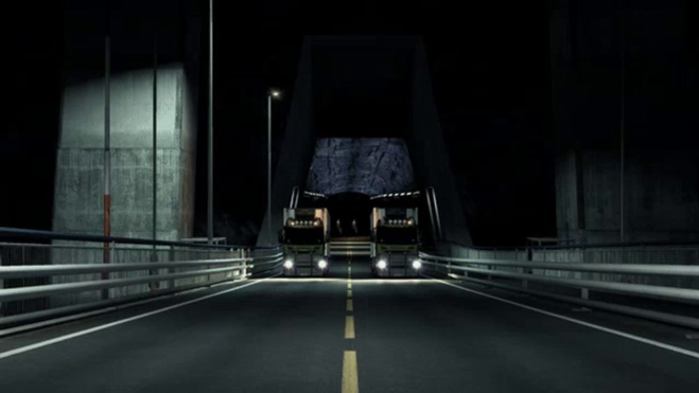 two scania trucks are driving across a bridge