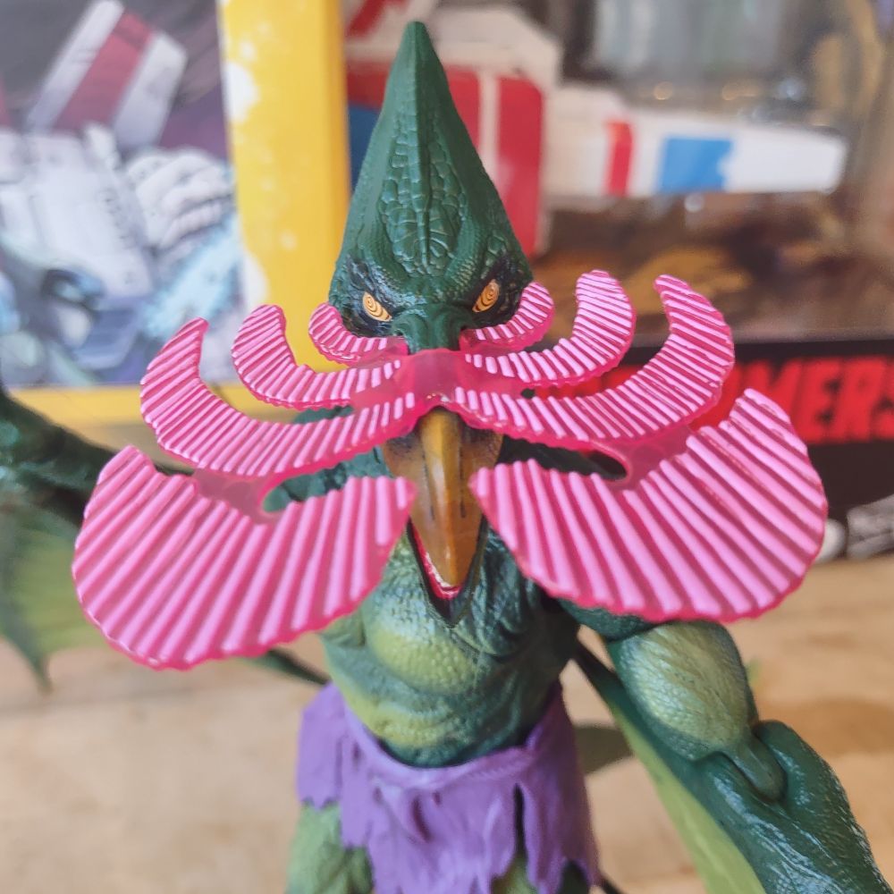 Sauron the pterodactyl man with an effects piece attached to his beak, creating the appearance of waves of glowing energy coming out from his swirling eyes.