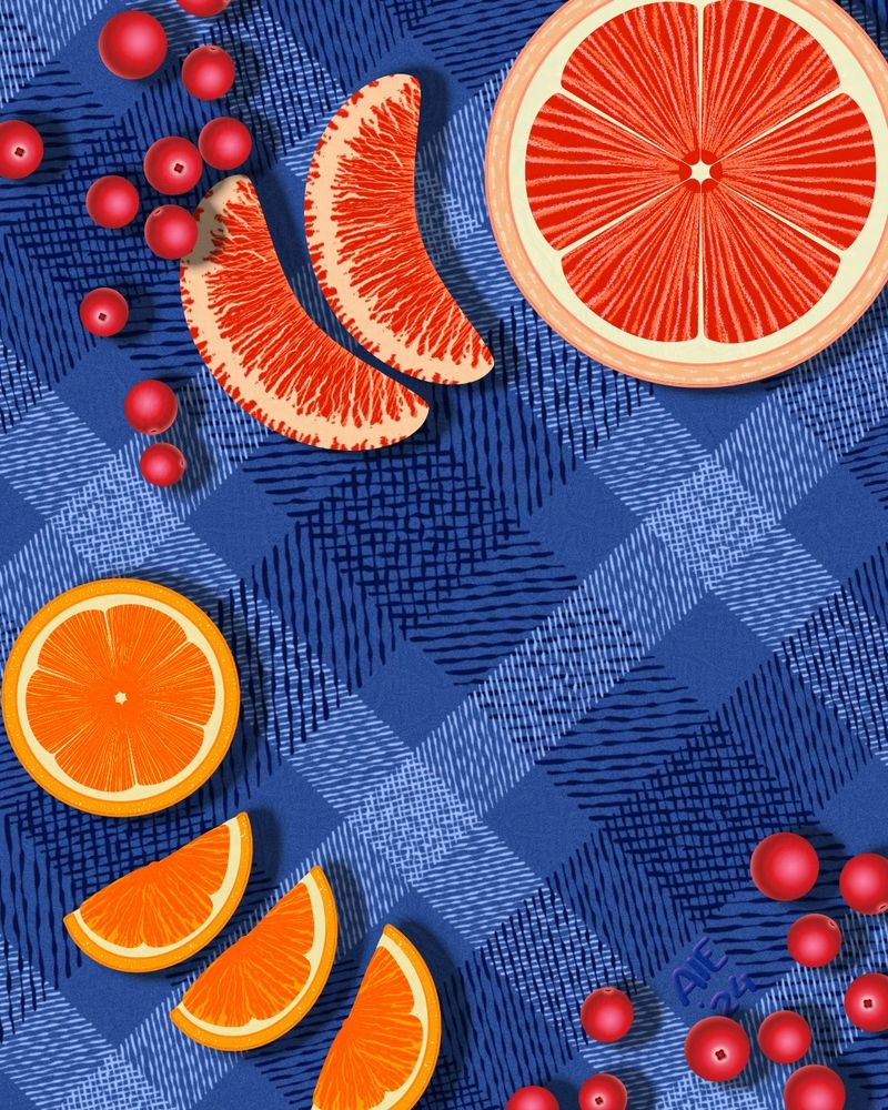 Grapefruit, oranges, and cranberries carefully arranged across a patterned tablecloth. 