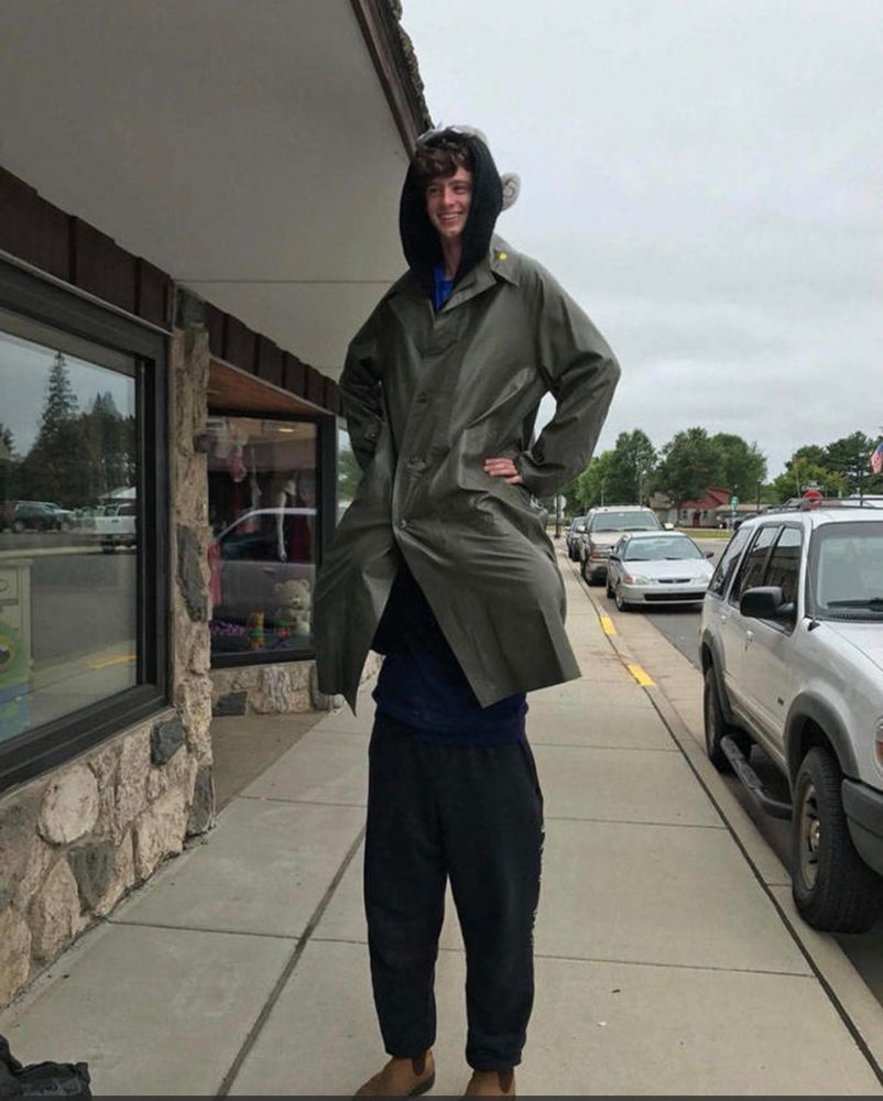Image of two teens in a trench coat