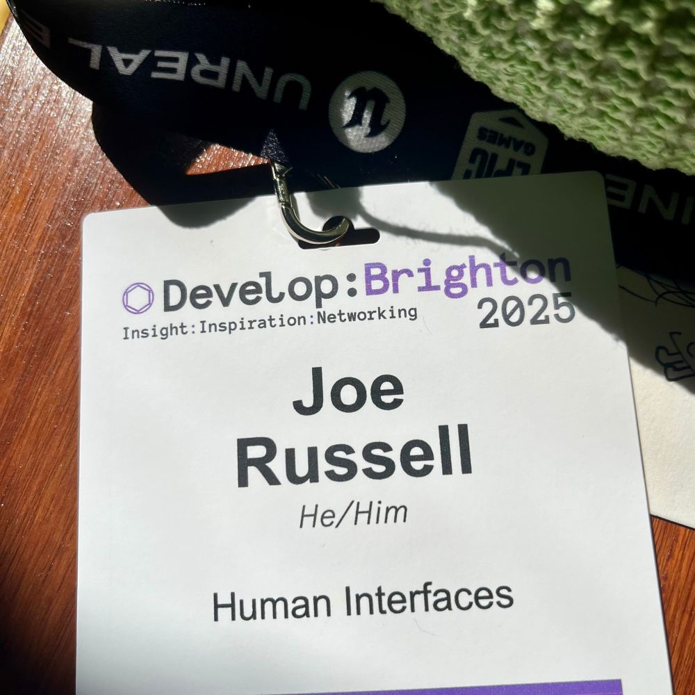A name badge for the Develop Brighton 2025 conference. Joe Russell. A knitted pear is in the corner of the photo.