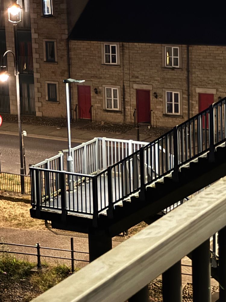 A nighttime photo of the stairs leading down from Carlisle Bridge on its’ Southern side