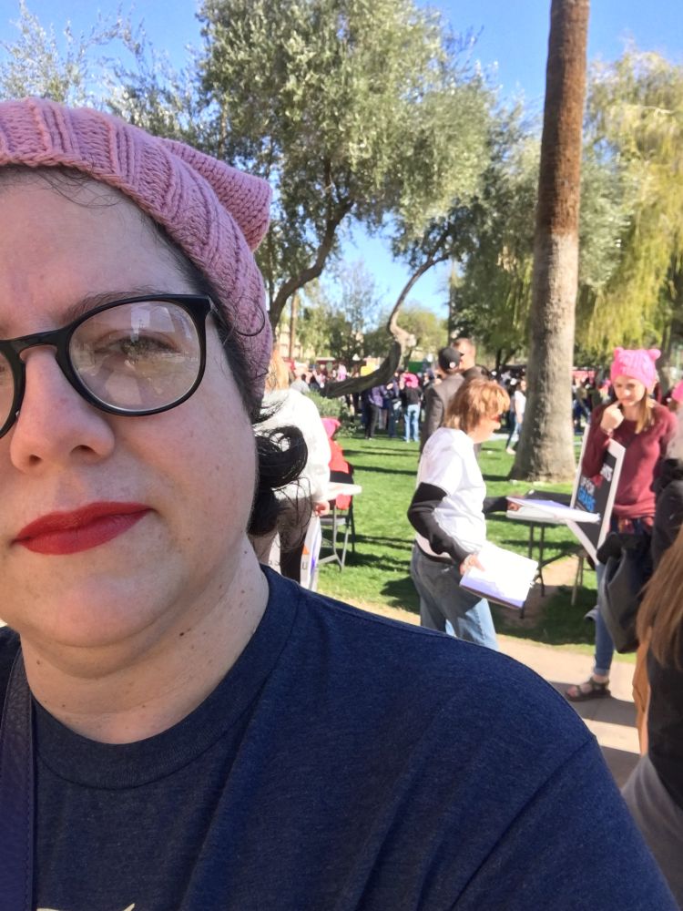Woman at a demonstration wearing a hand knit Pink Pussy hat
