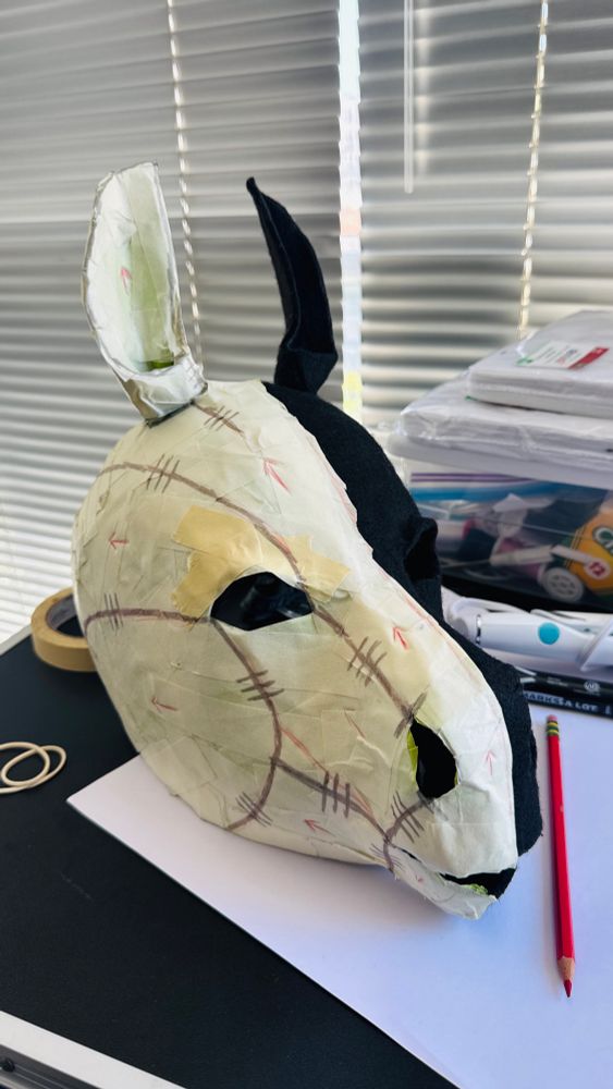A work in progress textile-based pony hood.  It has masking tape over half its face with pattern markings drawn on it.