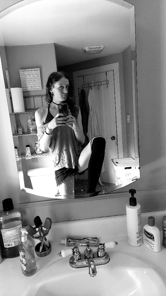 a greyscale bathroom mirror selfie of me (Daria)