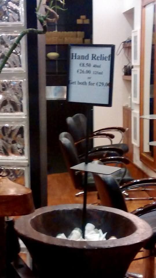 Photo of sign in hairdressers saying 'Hand Relief - €8.50 41ml, €26 121ml or get both for €29'.