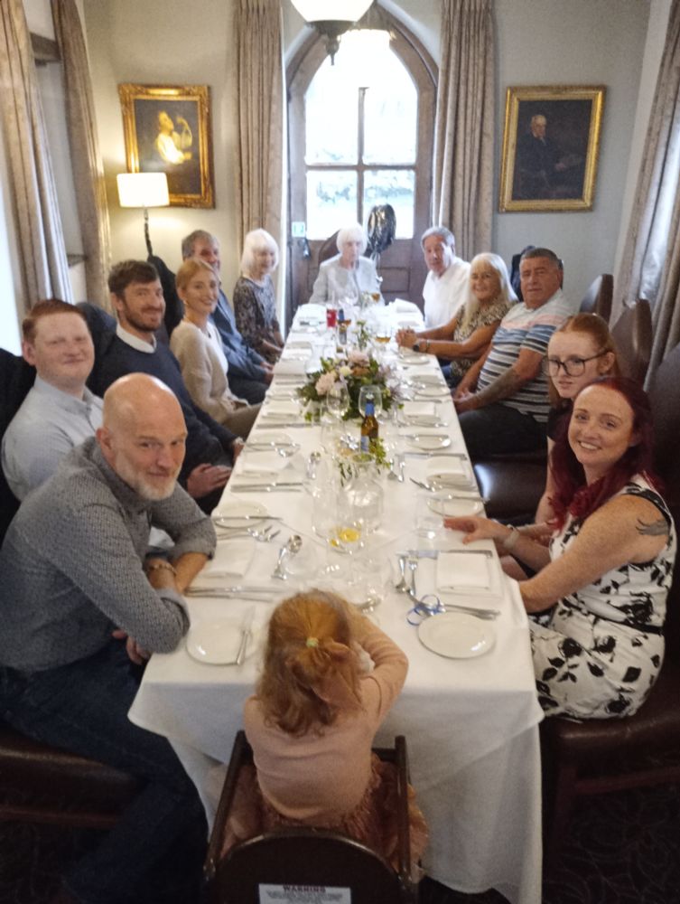 Photo of a long lunch table in a private room at Fawsley Hall with 14 guests awaiting lunch. 