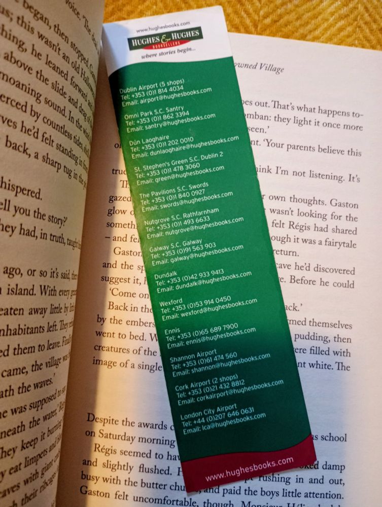 Photo of a Hughes & Hughes bookmark inside the book. It's green, white & red with a list of bookshops.