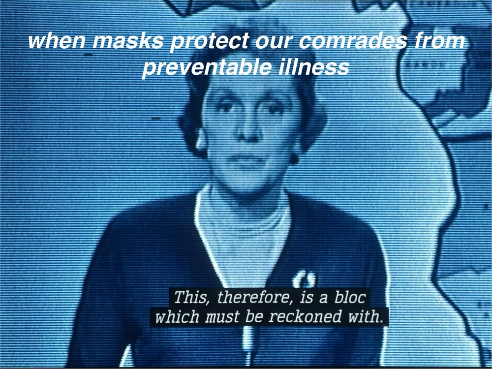 Big tone 1960s newscaster with short hair in cardigan. Top text reads “when masks protect our comrades from preventable illness” and text from newscast below reads “ this, therefore, is a bloc which must be reckoned with.”