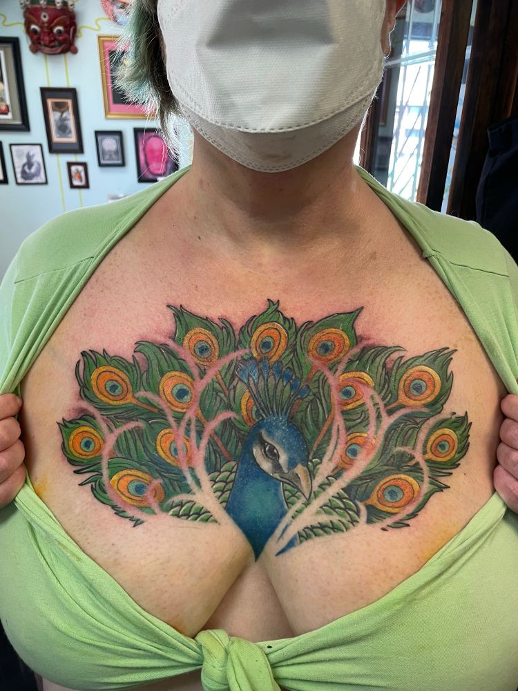 My kick ass peacock chest tattoo that uses negative space to imply the peacock is hiding in grasses