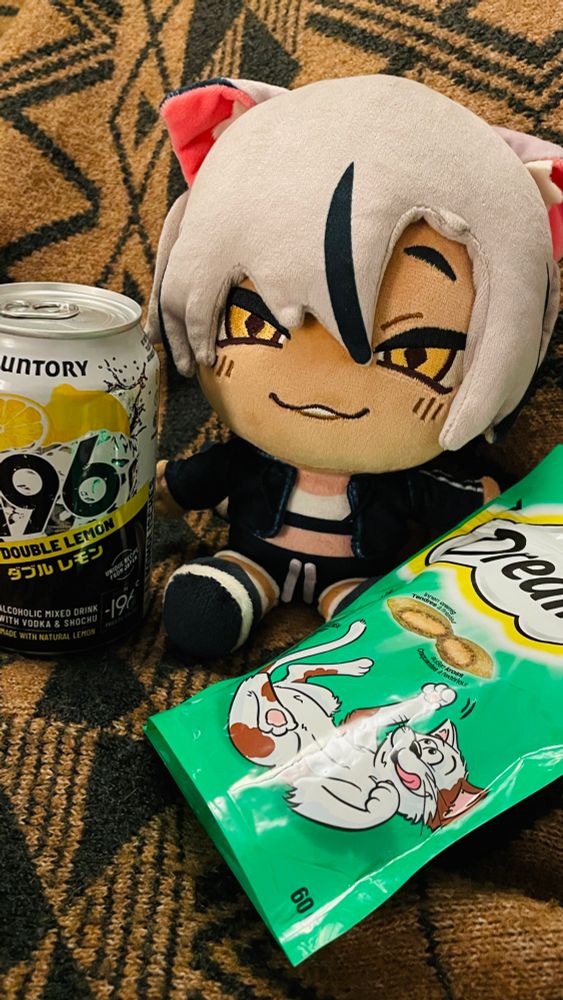 Kara plush next to a can of -196 double lemon and cat nip cat snacks