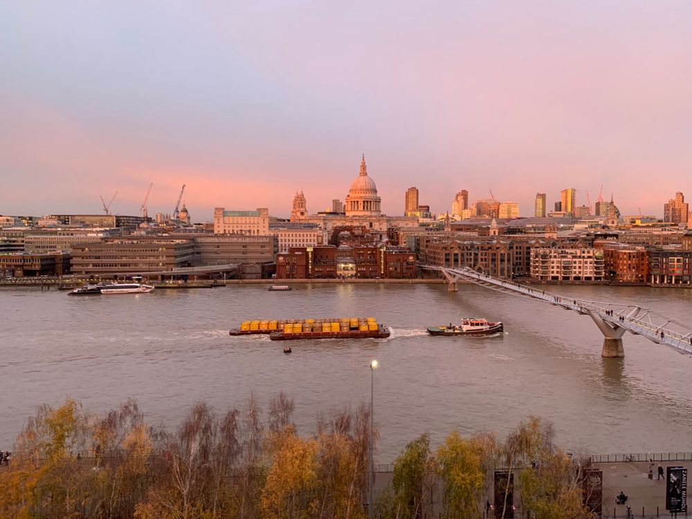 Photo of the view across the Thames to St Paul’s, the light is pink like alpenglow 
