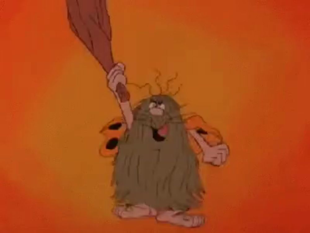 a cartoon caveman with a long beard is holding a large bat .