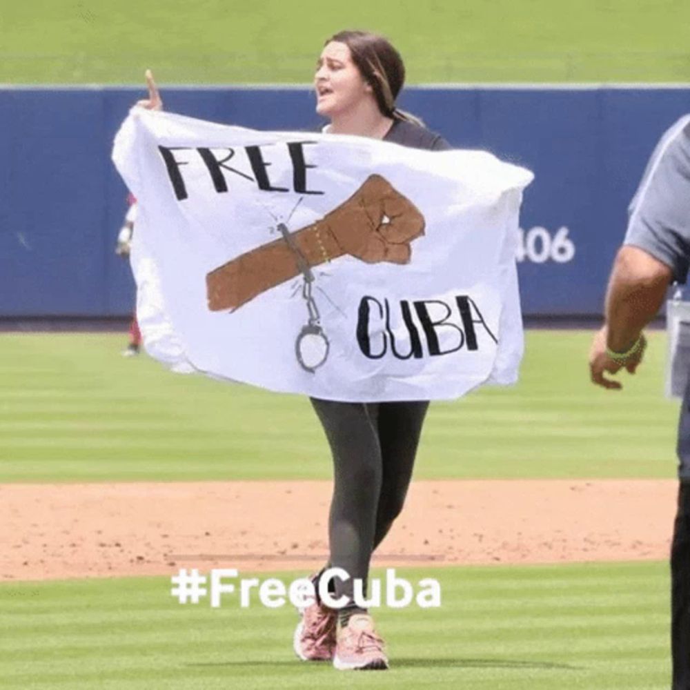 a woman is holding a white flag that says free cuba