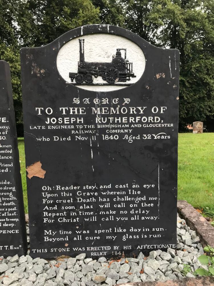 Elaborate headstones for Thomas Scaife and Joseph Rutherford, killed following the explosion of the boiler of the train they were driving, in Bromsgrove on 10 November 1840. Black faced with white text, poems on both, and images of a railway engine at the top of both.