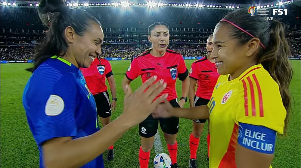 Marta and Leicy Santos smiling shaking hands after the coin toss ahead of a penalty shootout