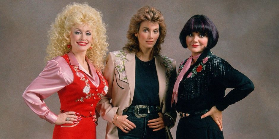 Dolly Parton, Emmy lou Harris and Linda rondstadt bedecked in nudie suit glory line up as the greatest trio of singers ever assembled 