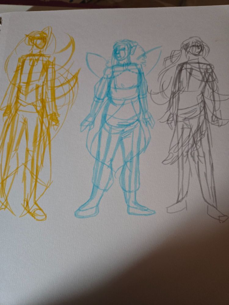 On a sketchbook page, 3 figures are drawn. The tallest on the far left is drawn in yellow, long hair, wings that turn up, diamonds are a reoccurring shape and a fancy outfit that leaves them barefoot. In the middle drawn in blue is a figure much more round in shape language, water drops are a reoccurring shape, much like her wings, she is also barefoot and has coils shoulder length hair. The last figure, drawn in Grey, has downturned wings, dressed sleek with sashes around their shoulders and waist, circles is a reoccurring shape, their hair is long but pulled back, they are also barefoot. The lighting of the image is on the darker side but the drawings are still visible
