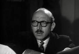 Lionel Jeffries wearing glasses, a suit and tie. He's 28. Trust me, he really is. I know he looks about 50, but I’ve done the maths.