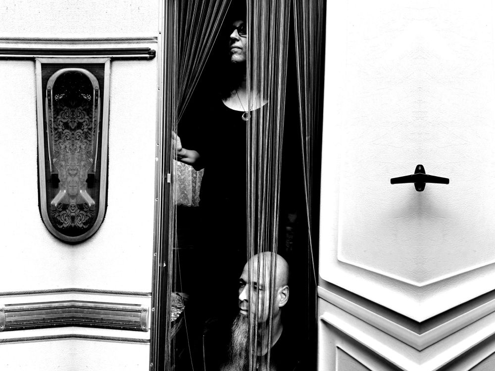 bw photo of Emerge / Anja Kreysing in the door of an old Tabbert Camper. 