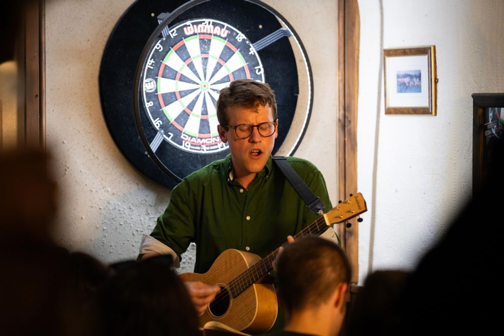 Me playing guitar and singing, part of a gig of me singing Bob Dylan songs in the pub. Photo credit Marcus Lai. 