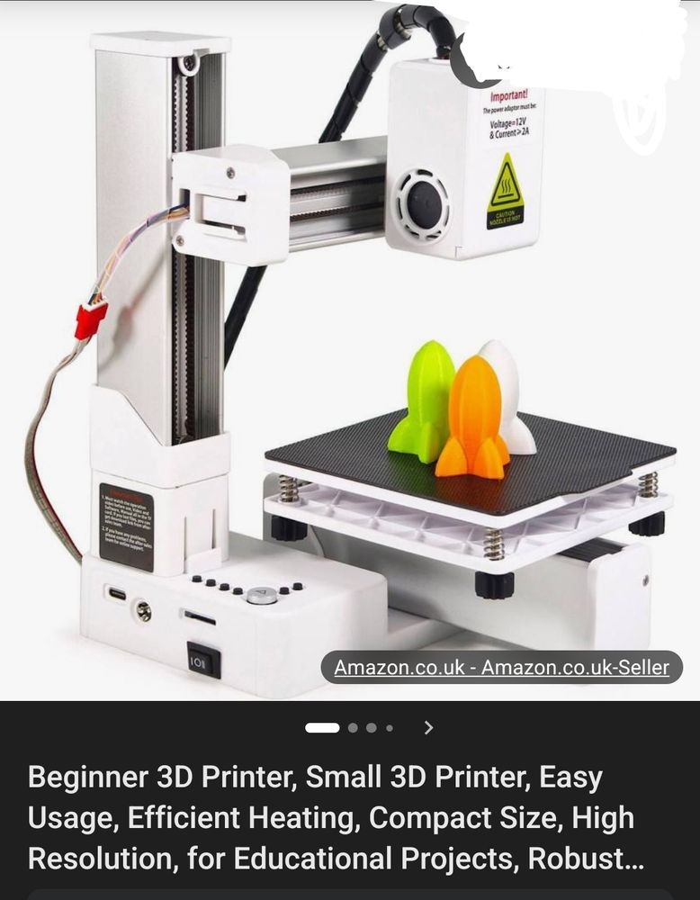 Beginner's 3D printer (sold on Amazon) with 3 missile-looking printouts sitting on its product plate.