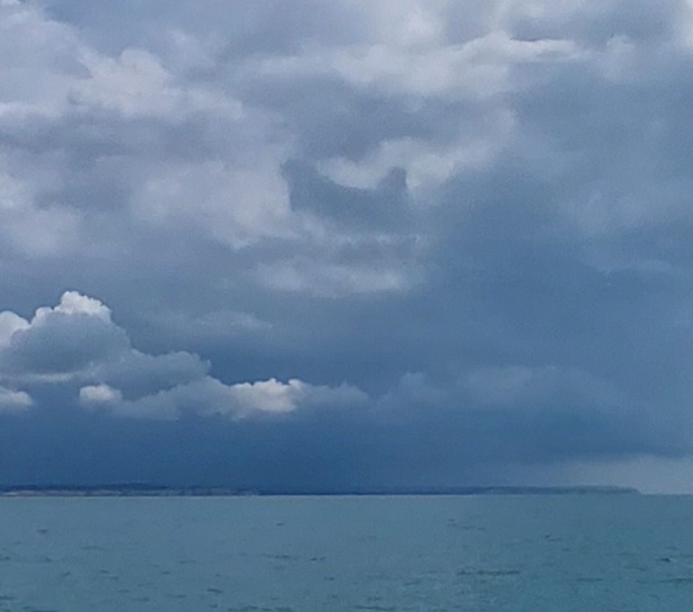 Seascape with heavy cloud. A small cloud in the centre of the skyscape looks a bit like a roosting hen.