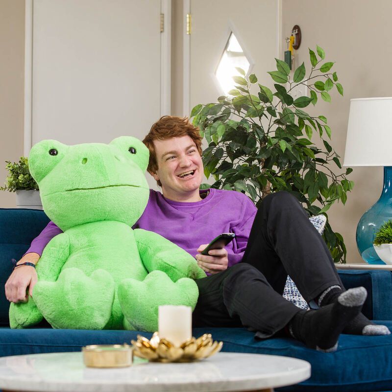 Just a man and his giant stuffed frog, living their best life.
