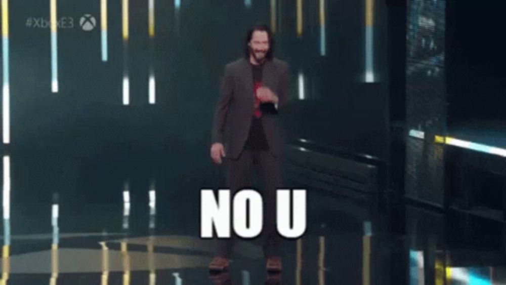 a man in a suit is dancing in front of a sign that says no u on it