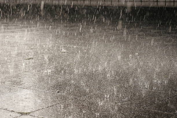 Heavy rain bouncing off a sidewalk.