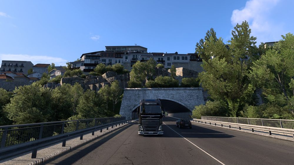 A picture from within European Truck Simulator 2(ETS2) of my truck exiting and driving away from a tunnel.