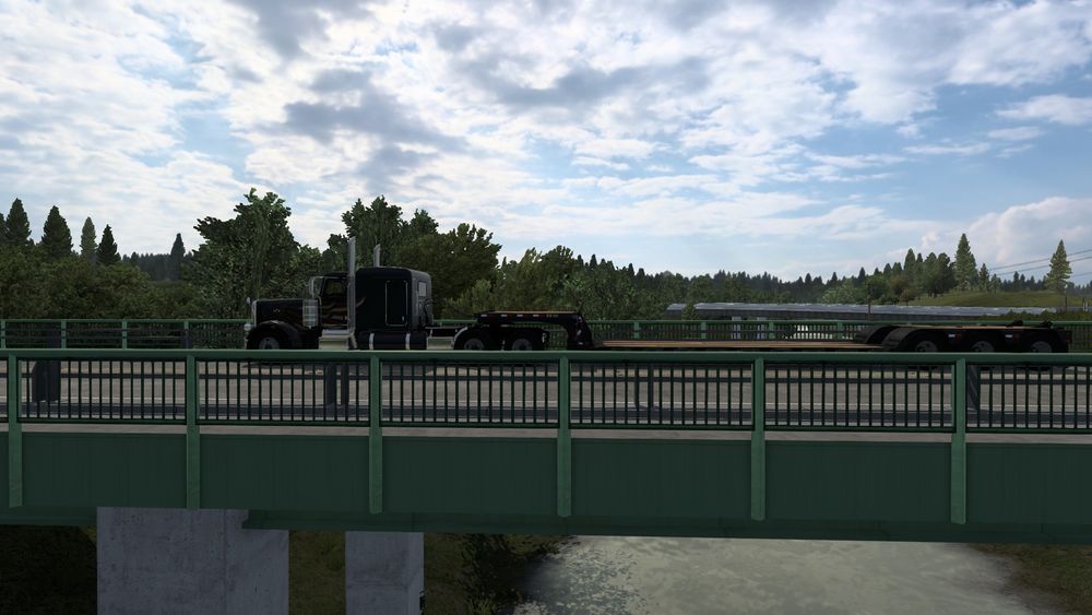 A picture from within American Truck Simulator(ATS) of my Truck and Trailer crossing a bridge.
