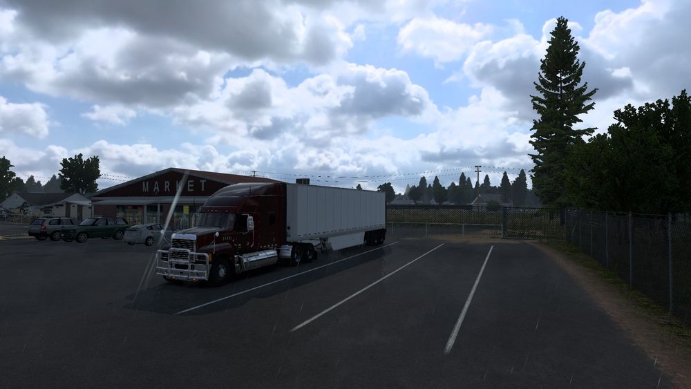 A picture from within American Truck Simulator(ATS) of my truck and trailer taking a break, while a train passes in the background.