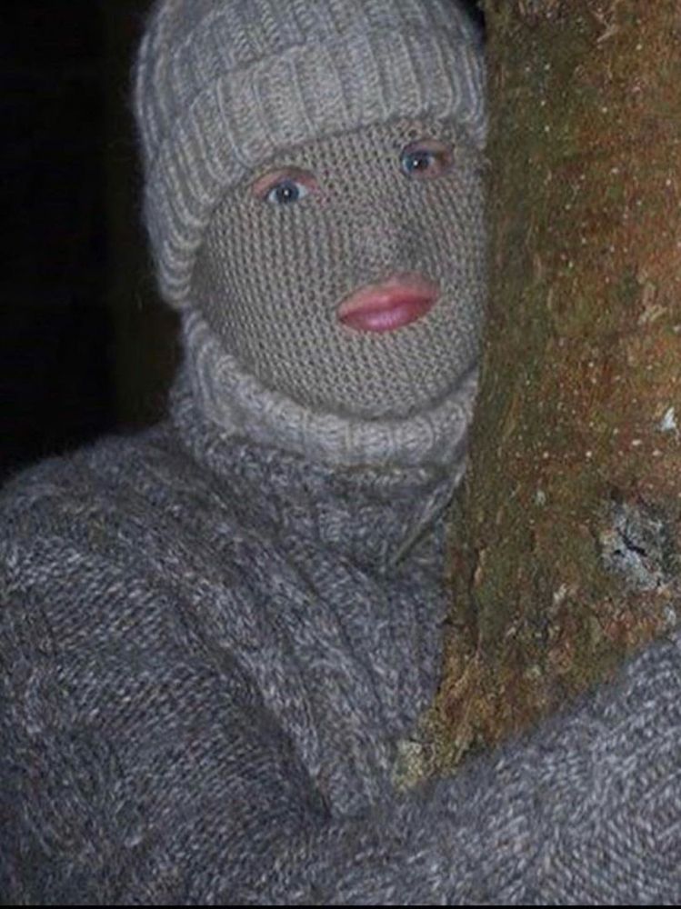 A person completely covered in grey knit wool