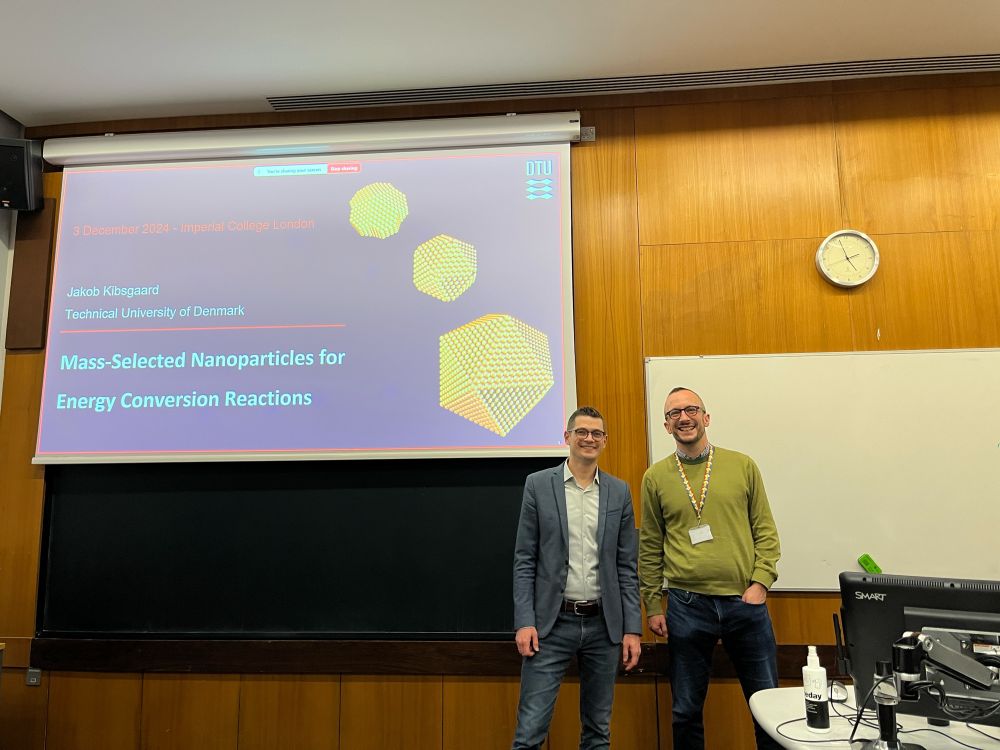 Jakob and Ifan standing in front of projector screen as Jakob is about to give a talk.