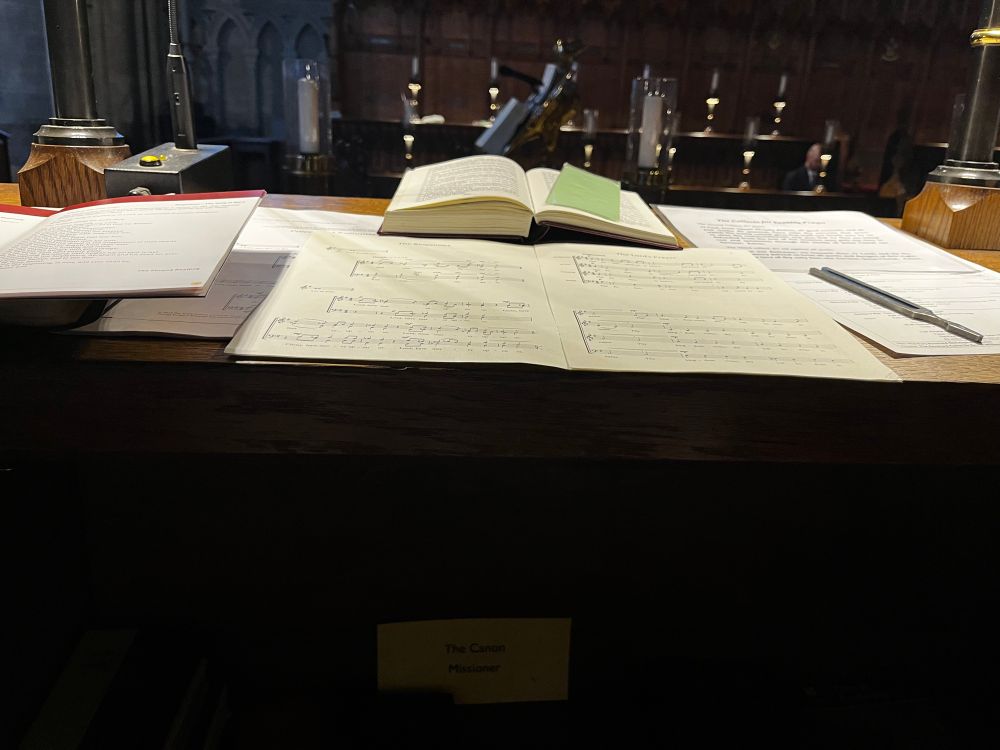 A choir stall with open music and a tuning fork 