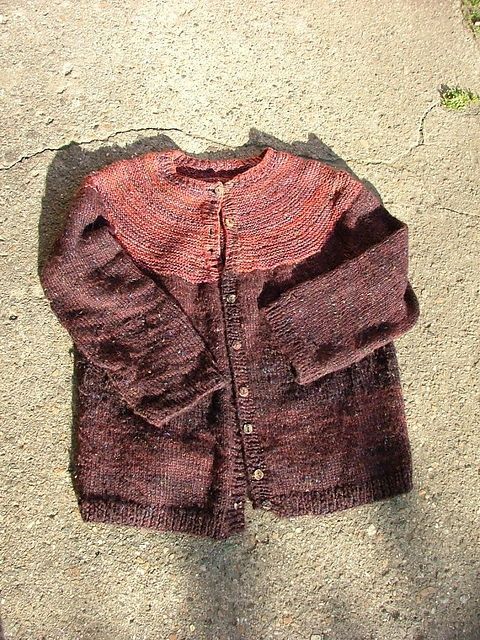 Cardigan with red toned yoke in garter stitch. Body in black in stocking stitch. Pattern from Ann Budd's book The Knitters Book of Sweater Patterns