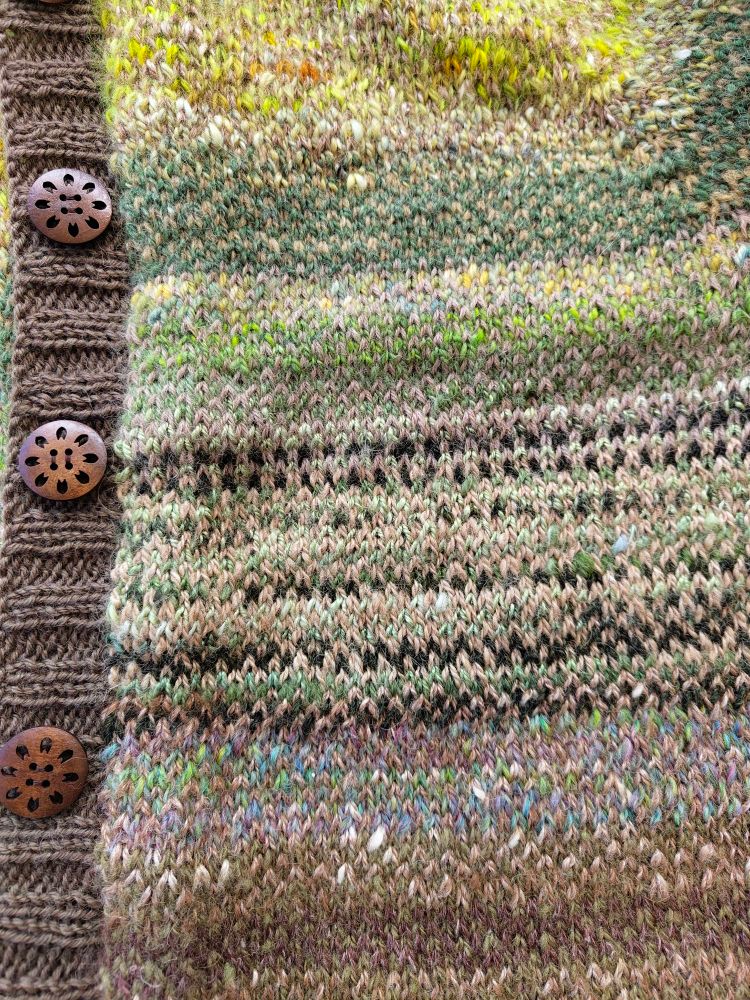 Green & brown cardigan in alternating colour stitches, wooden buttons with fretwork details 