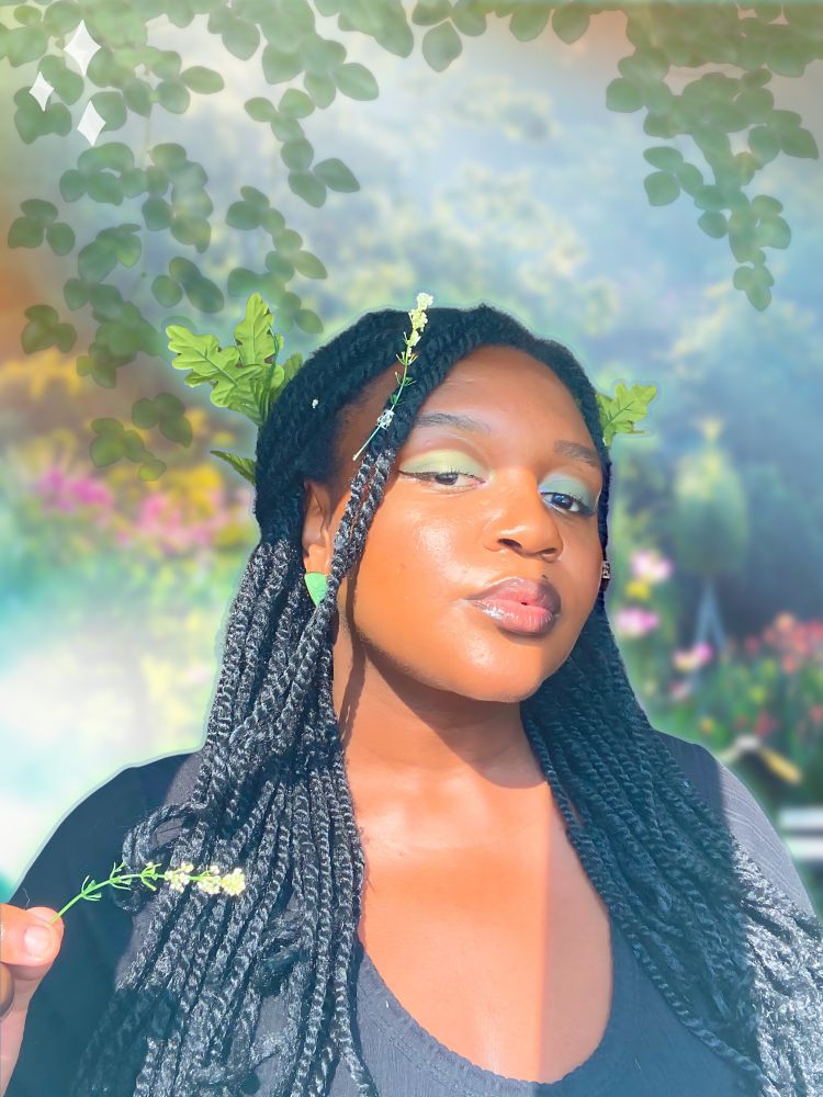 Pink with green leaves in her hair. The theme is the color pink. The background is green with leaves and flowers.