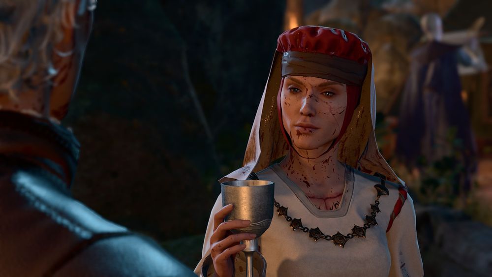 An in-game screenshot of my durge Amarie talking to Astarion. Amarie is an elf with a pallid skintone and pale yellow eyes. She is wearing a white and red dress along with a white and red wimple; in addition to this, she is also wearing a large metal necklace. She is holding a goblet and is looking away from the viewer with a somber expression on her face. She is covered in blood. Astarion is to the very left of the frame with his back to the viewer, and is wearing his brown spawn route epilogue outfit. Amarie's face is fully in the frame and she is shown from the chest up. Withers is also in the picture in the background: he is standing out of focus to the right of Amarie and is writing on a scroll.