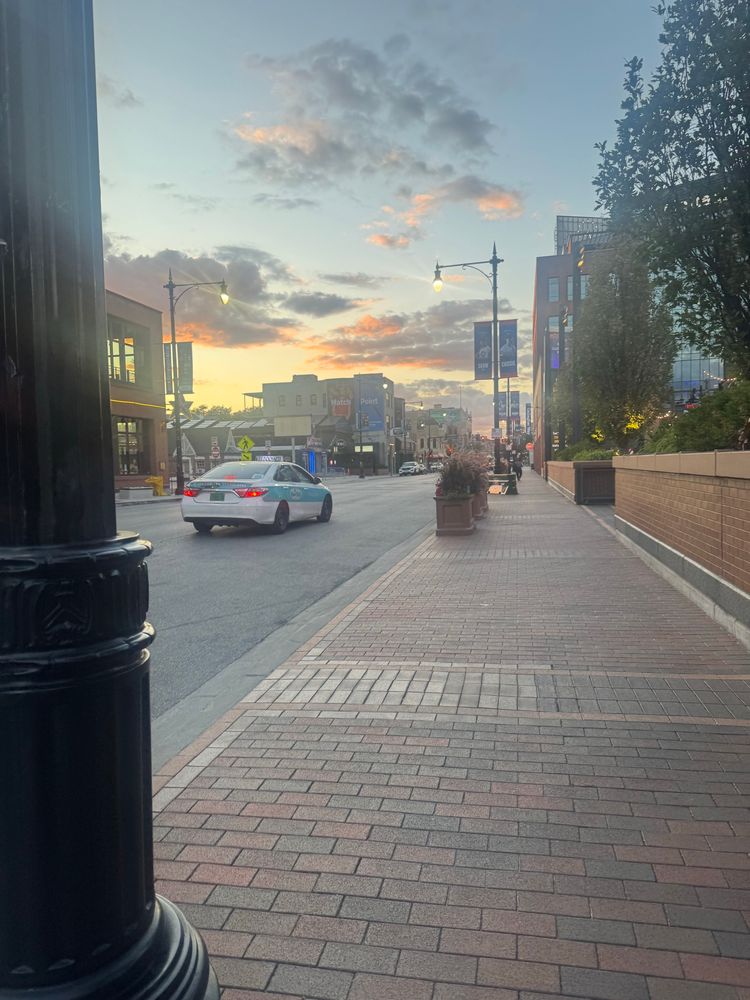 a light blue and yellow sky with pink-tinged clouds 