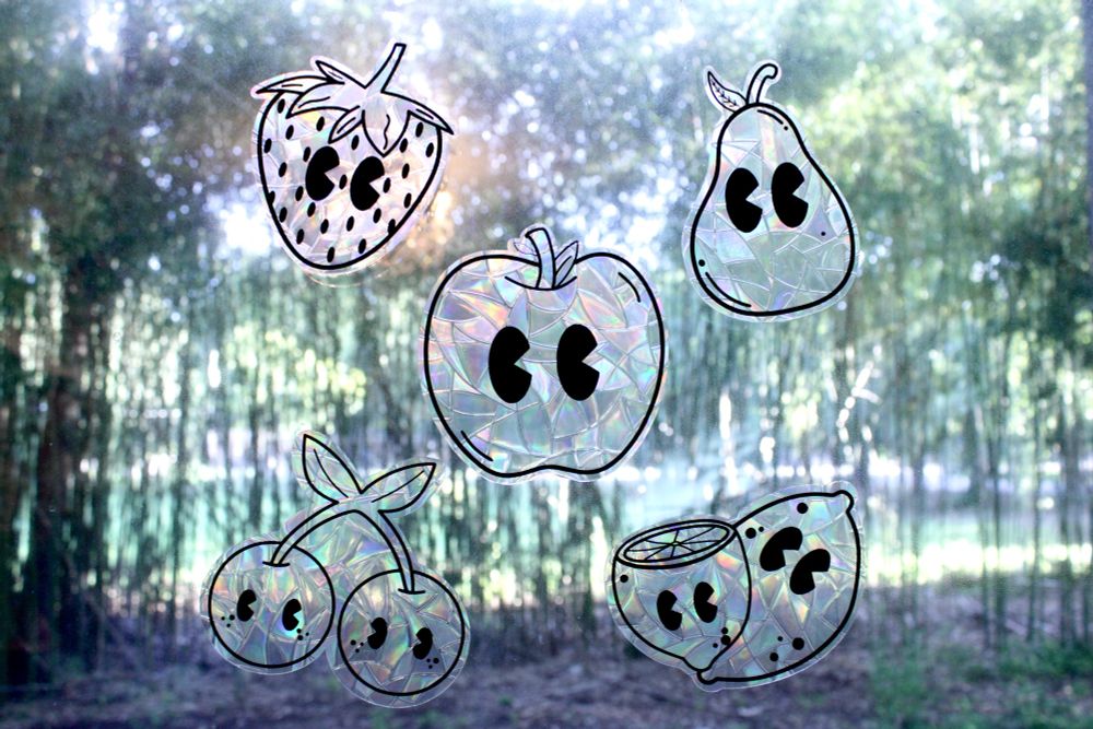 Rainbow film sun catchers that feature cartoon cherries, an apple, a pear, lemons, and a strawberry