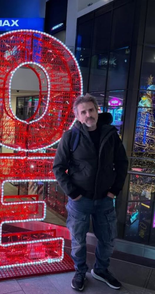 Con O'Neill standing by a sign cut out of the picture 