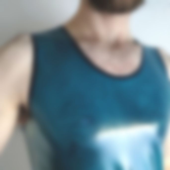 blurry photo of my chest and beard in a shiny tank top