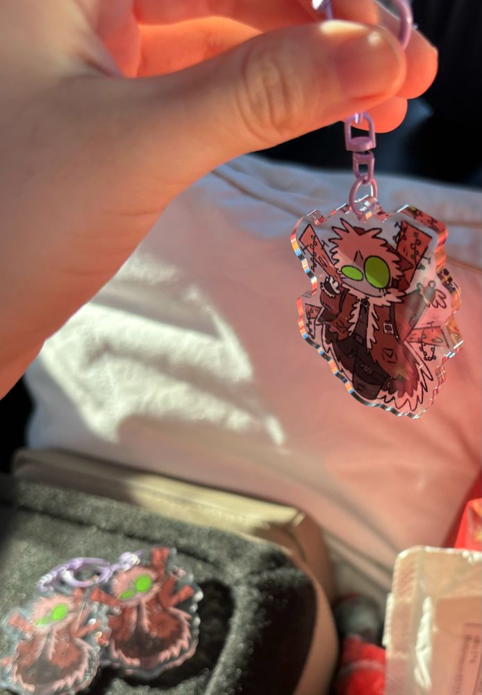 me holding crackpot keychain up with two other crackpots in the background