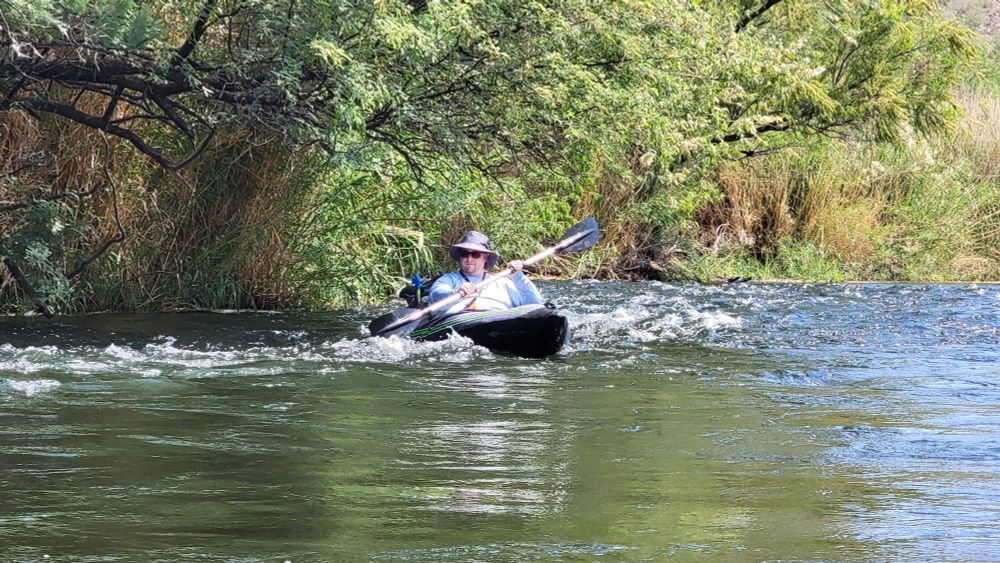 Me floating on the salt river in Arizona in a kayak, navigating very light rapids. 